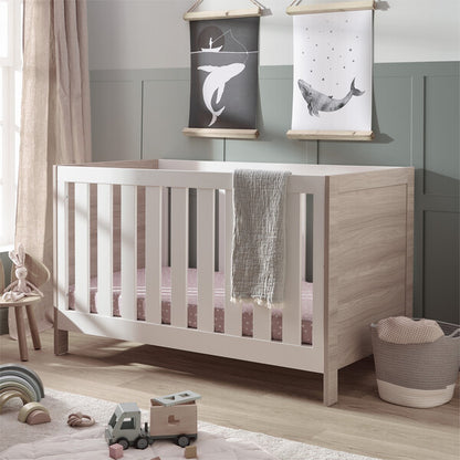 Silver Cross Finchley Oak Cot Bed angled in lifestyle shot